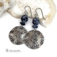 These handcrafted earrings have a modern bold edgy vibe. They feature rustic hammered and hand stamped silver tone pewter dangles accented with natural snowflake obsidian gemstones. The stones have a natural pattern in hues of black and soft gray. This stone is a natural volcanic glass which contains the mineral cristobalite - which creates the "snowflake" type patterns. Bold and striking - they're sure to make a statement. Perfect for women that love natural stones and unique artisan handmade jewelry. 