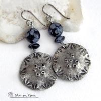 These handcrafted earrings have a modern bold edgy vibe. They feature rustic hammered and hand stamped silver tone pewter dangles accented with natural snowflake obsidian gemstones. The stones have a natural pattern in hues of black and soft gray. This stone is a natural volcanic glass which contains the mineral cristobalite - which creates the "snowflake" type patterns. Bold and striking - they're sure to make a statement. Perfect for women that love natural stones and unique artisan handmade jewelry. 