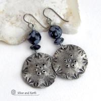 These handcrafted earrings have a modern bold edgy vibe. They feature rustic hammered and hand stamped silver tone pewter dangles accented with natural snowflake obsidian gemstones. The stones have a natural pattern in hues of black and soft gray. This stone is a natural volcanic glass which contains the mineral cristobalite - which creates the "snowflake" type patterns. Bold and striking - they're sure to make a statement. Perfect for women that love natural stones and unique artisan handmade jewelry. 