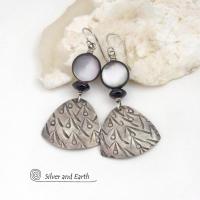 These handcrafted sterling silver earrings have a hand stamped texture and feature round black lip Mother-of-Pearl beads and tiny black onyx stones. The Mother of Pearl has a natural shimmery white hue with "rims" of black. They have a modern elegant chic style that will look great dressed up or down.