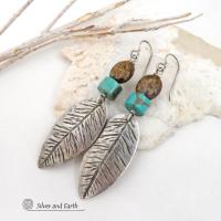These handcrafted sterling silver feather earrings have a hand stamped texture and are accented with turquoise and bronzite stones which bring out the natural brown matrix in the turquoise stones. They have a native southwestern vibe that makes a bold statement. The earrings are handmade and are a beautiful example of southwest style jewelry. New Mexio True certified. 