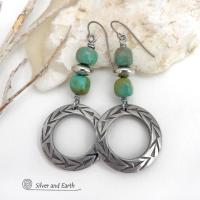 These handcrafted earrings feature silver pewter hoops with a hand stamped texture accented with natural, genuine turquoise stones and silver plated beads. Lightweight and comfortable to wear, they have an earthy modern style with southwest flair that coordinates beautifully with all wardrobe types. Handmade in the USA by Silver and Earth Jewelry, a Certified New Mexico True business.