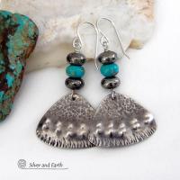 These handcrafted sterling silver earrings feature a unique hand textured design and are accented with natural turquoise and metallic gray pyrite stones. They have a southwestern boho tribal flair and will make a striking statement. The pyrite stones add a touch of natural sparkle and shine. Handmade in the USA by Silver and Earth Jewelry. 