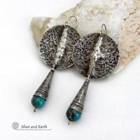 Big and bold - these handcrafted sterling silver earrings have an earthy, organic design with an edgy, modern southwest style. They feature solid sterling silver with a rustic, hammered texture and a dark oxidized finish. They are accented with hammered and hand stamped sterling silver cones and natural turquoise stone beads. Perfect for women that love to wear bold organic looking jewelry with a subtle southwest style and flair. Handmade in USA by Silver and Earth, a New Mexico True Certified Business.