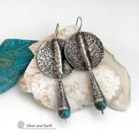 Big and bold - these handcrafted sterling silver earrings have an earthy, organic design with an edgy, modern southwest style. They feature solid sterling silver with a rustic, hammered texture and a dark oxidized finish. They are accented with hammered and hand stamped sterling silver cones and natural turquoise stone beads. Perfect for women that love to wear bold organic looking jewelry with a subtle southwest style and flair. Handmade in USA by Silver and Earth, a New Mexico True Certified Business.