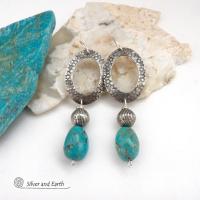 These handcrafted earrings feature hand stamped sterling silver oval hoops accented with natural turquoise stone nuggets and textured silver plated beads. They have a chic modern style with touch of southwestern flair that will coordinate beautifully with all wardrobe types. Handmade in the USA by Silver and Earth Jewelry. 
