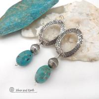 These handcrafted earrings feature hand stamped sterling silver oval hoops accented with natural turquoise stone nuggets and textured silver plated beads. They have a chic modern style with touch of southwestern flair that will coordinate beautifully with all wardrobe types. 
