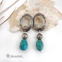 These handcrafted earrings feature hand stamped sterling silver oval hoops accented with natural turquoise stone nuggets and textured silver plated beads. They have a chic modern style with touch of southwestern flair that will coordinate beautifully with all wardrobe types. Handmade in the USA by Silver and Earth Jewelry. 