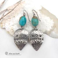 These handcrafted earrings feature natural turquoise nuggets accented with sterling silver dangles with a hammered and hand stamped texture. The stones are a gorgeous shade of turquoise with a natural copper matrix. They have an earthy organic, modern style with southwestern flair. The earrings are handmade and are a beautiful example of southwest style jewelry. Handmade by Silver and Earth, a New Mexico True Certified business.