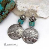 These handcrafted earrings feature uniquely textured hammered and hand stamped sterling silver accented with natural turquoise stones and silver plated beads. Bold and striking, they have a modern, southwest style with a touch of tribal flair. Handmade in the USA by Silver and Earth Jewelry. 