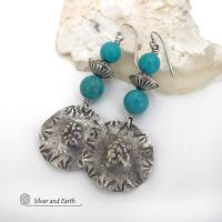 These handcrafted sterling silver earrings have a rustic hammered and hand stamped texture and are accented with a stack of turquoise and sterling silver beads. The silver beads have a fluted corrugated texture and an oxidized satin finish. Bold and striking, they have an earthy organic vibe with southwest style and flair that will look great with all types of outfits. Handmade by Silver and Earth, a New Mexico True Certified business. 
