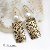 These handcrafted earrings feature gold brass rectangles with an intricate hand stamped texture accented with white freshwater pearls. They have a modern, elegant chic and feminine style that looks great dressed up or down. They'll make a great gift for couples celebrating their 21st wedding anniversary - brass is the traditional choice for this occasion. Also makes a great birthday gift for someone born in June - pearl is the birthstone for that month. Handmade in the USA by Silver and Earth Jewelry. 