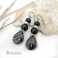 The earrings feature natural zebra jasper stones accented with black beads and silver plated beads and dangle from hypoallergenic titanium ear wires. This stone is known as zebra jasper because of the natural striped matrix that resembles a zebra's pattern. It's a striking stone with earthy hues of soft gray, along with streaks of black. They'll make a great gift for a natural stone lover - or a nice addition to your own jewelry wardrobe. Handmade in the USA by Silver and Earth Jewelry. 