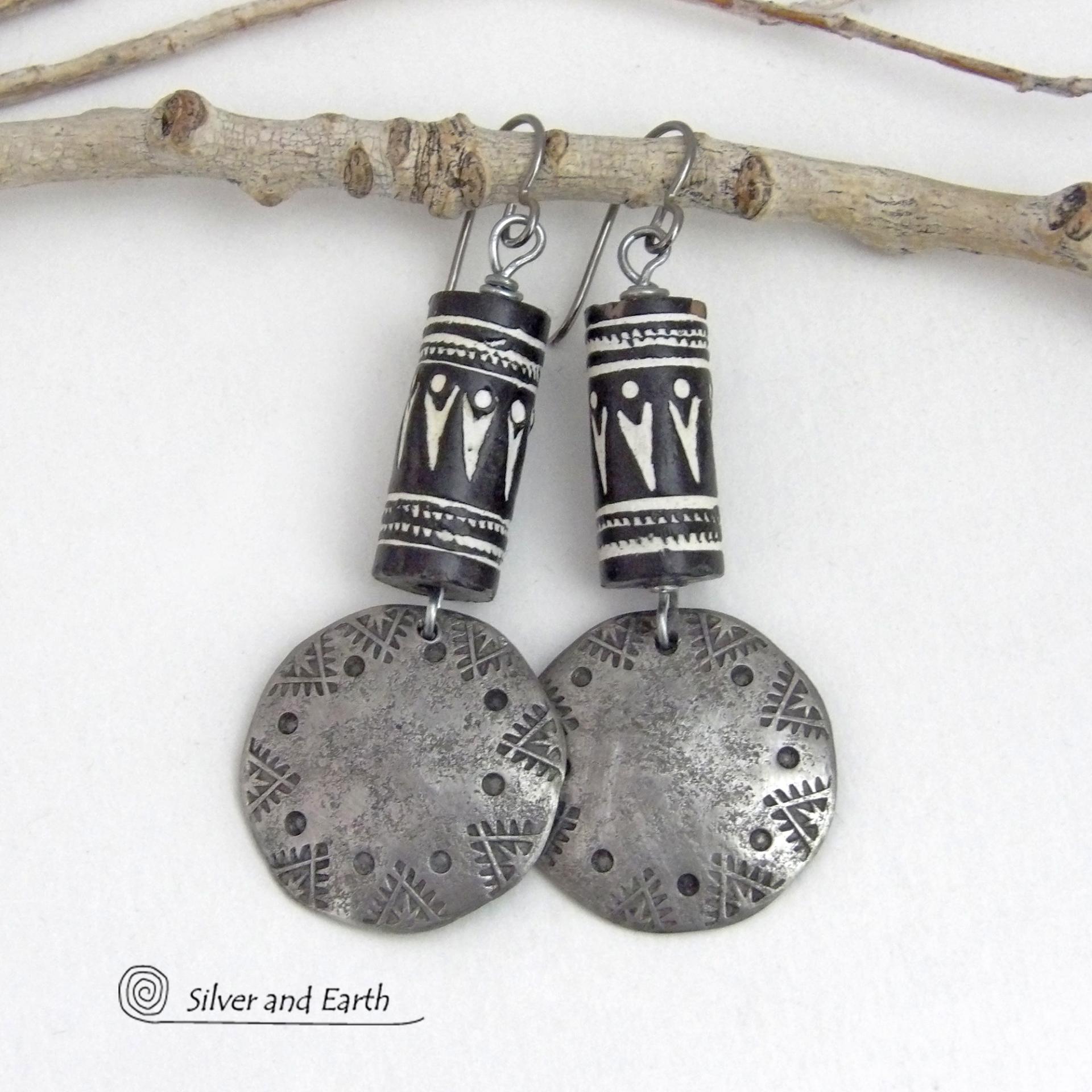These silver pewter earrings have a rustic, hammered and hand stamped texture and are accented with handmade African tube-shaped beads with a striking black and white pattern. Bold and striking, they'll make a ethnic tribal statement. Perfect for women that unique and one of a kind artisan handcrafted jewelry. Handmade in the USA by Silver and Earth Jewelry.