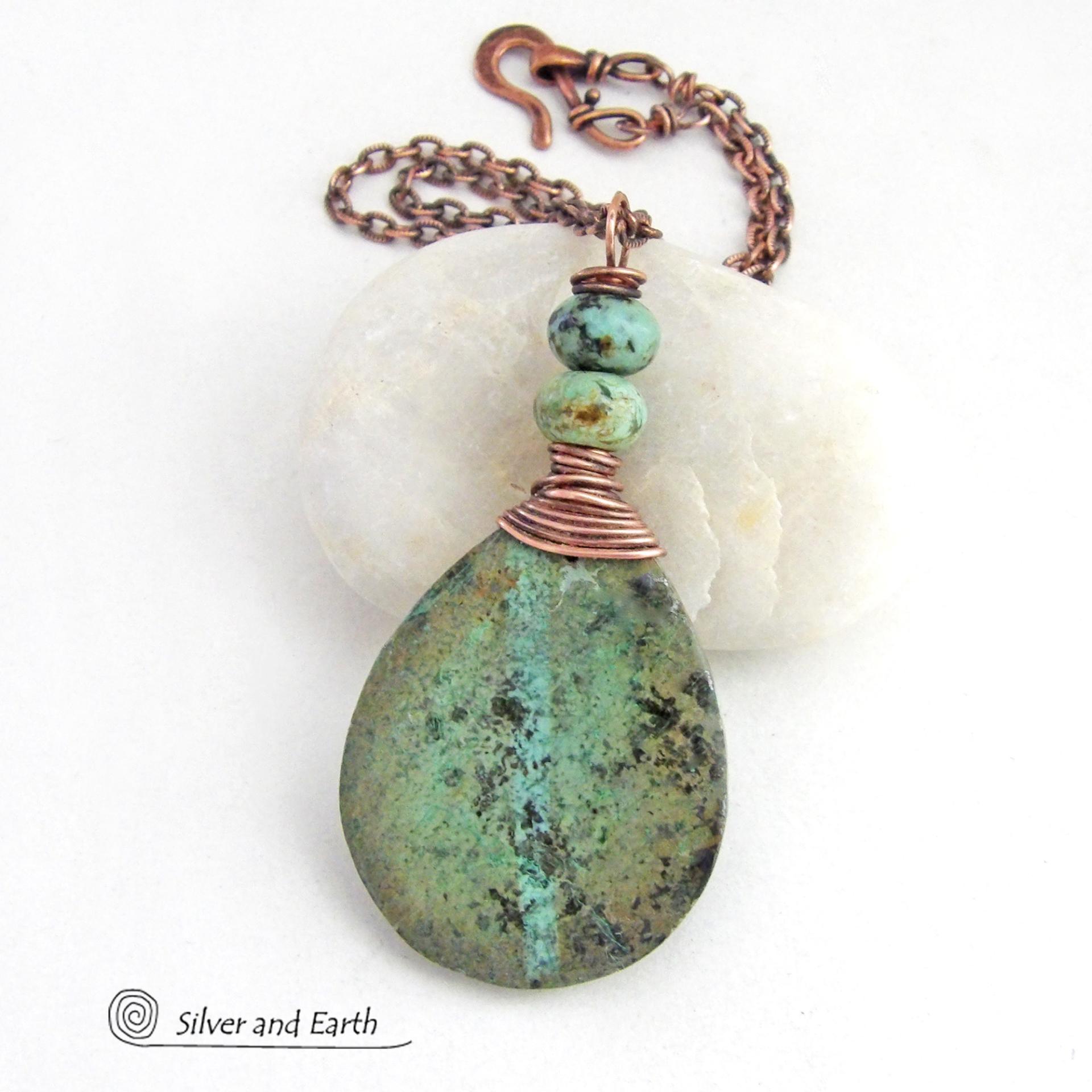 This one-of-a-kind necklace features a natural African turquoise stone wrapped in copper wire and accented with African turquoise stone beads. The stone has an earthy, organic feel with hues of dark blue-green, along with a subtle natural black matrix. It will make a great gift for a natural stone lover - or a nice addition to your own jewelry collection. 
