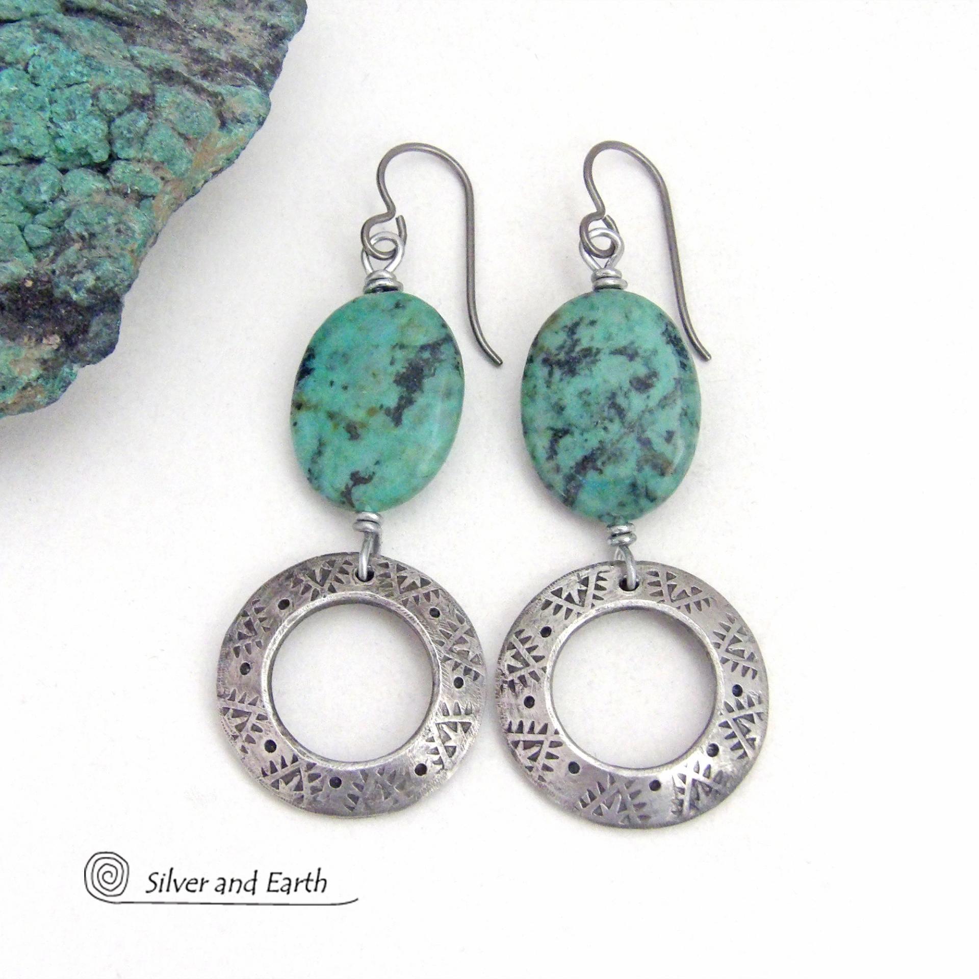 Unique and one-of-a-kind, these artisan handcrafted earrings feature natural African turquoise stones accented with silver tone pewter dangles with a hand stamped texture and oxidized finish. They have an earthy, modern style with a touch of southwestern flair. Coordinating necklace sold separately.
