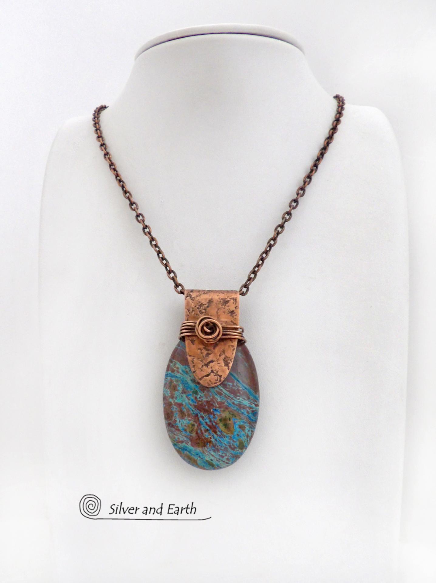 This pendant necklace features a beautiful aqua jasper gemstone with stunning hues of blue and brown accented with a hand forged copper bail with a lightly hammered texture. It's accented with twists of solid copper wire which forms a spiral in front. Unique and one-of-a-kind, it makes a great gift for a natural stone lover - or a nice addition to your own jewelry collection.