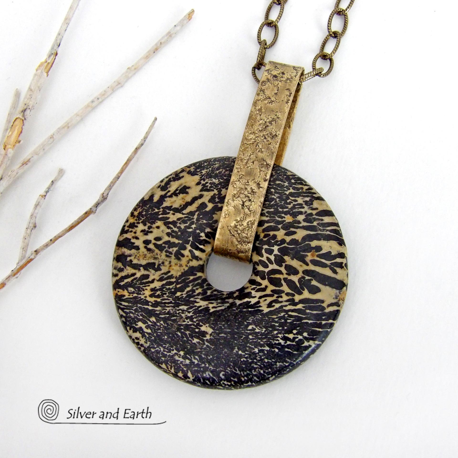 This one-of-a-kind pendant necklace features a stunning artistic jasper stone accented with a hand forged gold brass bail. This type of jasper is known for its intricate, natural patterns that resemble brushstrokes, landscapes, or abstract art. The stone in this piece has a natural bold dramatic pattern in hues of black and soft golden yellow with black streaks that resemble "feathery" dendrites. The design is modern and bold - yet classic and always in fashion. It can be worn by either a man or women. 
