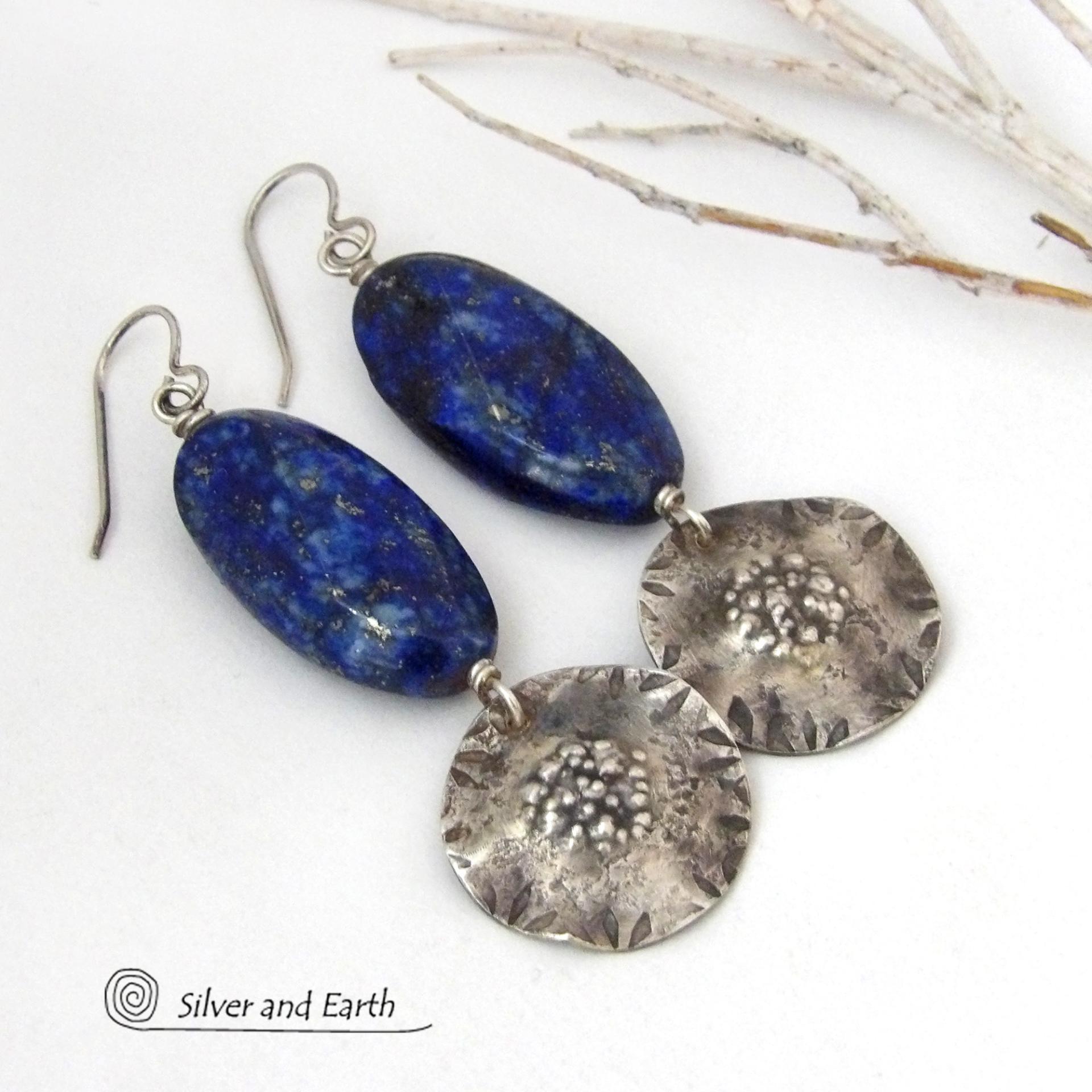 Handcrafted earrings with large blue lapis lazuli gemstones with a faceted finish accented with sterling silver dangles. Unique and one-of-a-kind, they'll make a bold statement.