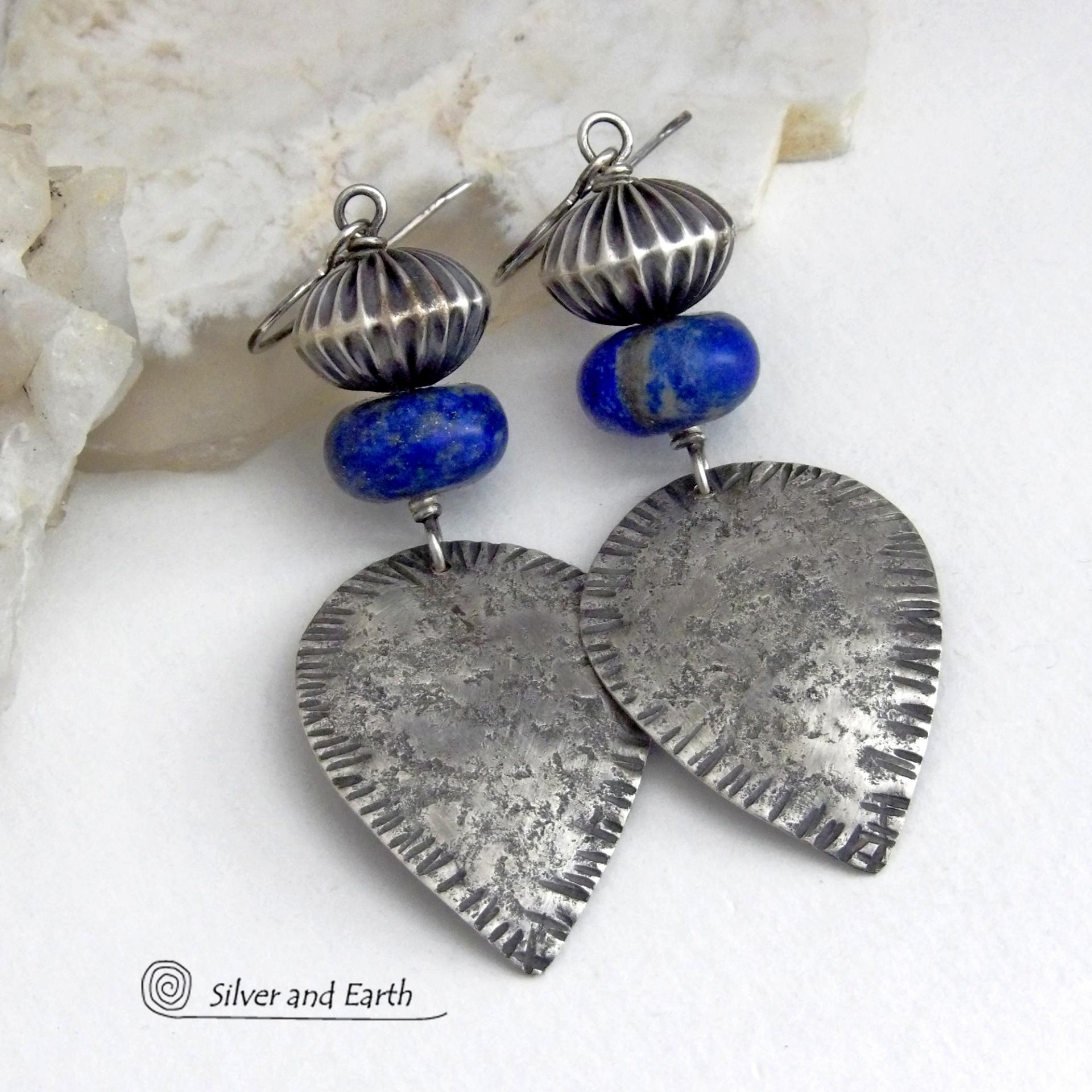 Big and bold - these earrings feature handcrafted sterling silver dangles with a rustic, organic texture accented with chunky natural blue lapis lazuli gemstones and Native style oxidized sterling silver beads with a rich, corrugated texture. They have a modern southwestern and tribal flair that makes a bold statement. Perfect for women that love artisan handcrafted southwest Santa Fe style jewelry. Handmade in the USA by Silver and Earth Jewelry - a New Mexico True Certified Business. 