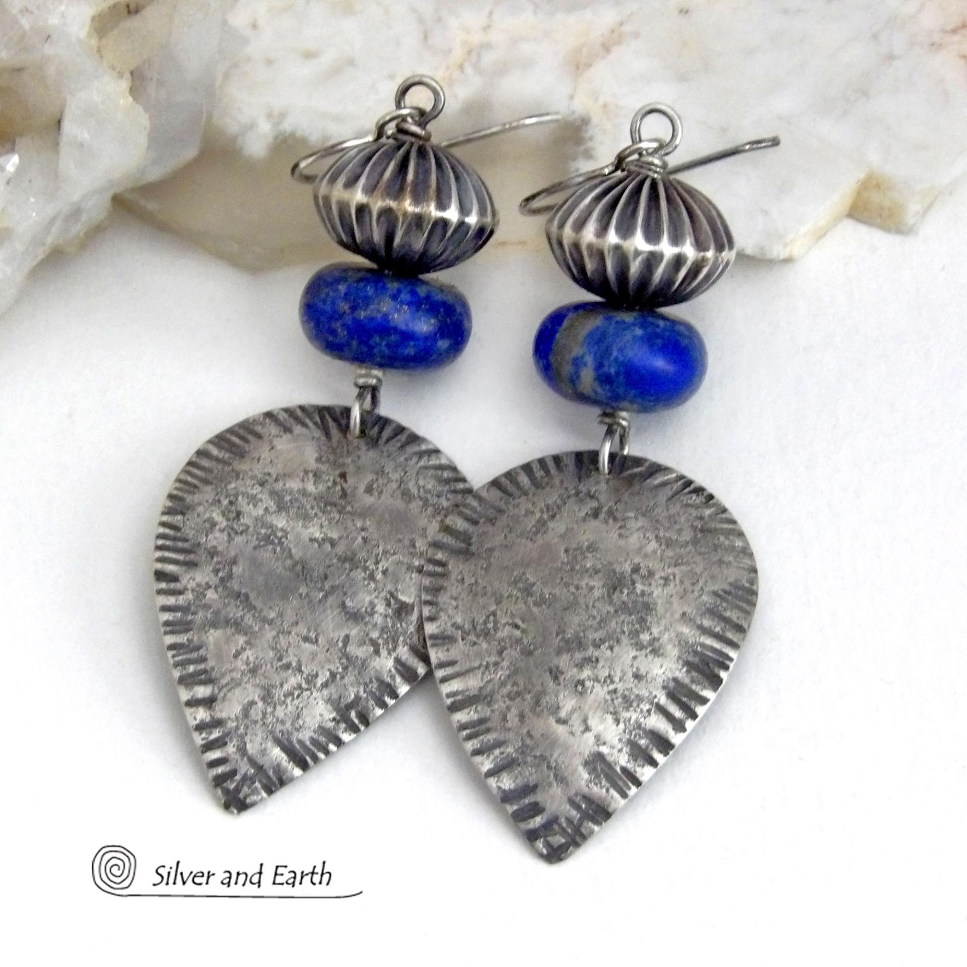 Big and bold - these earrings feature handcrafted sterling silver dangles with a rustic, organic texture accented with chunky natural blue lapis lazuli gemstones and Native style oxidized sterling silver beads with a rich, corrugated texture. They have a modern southwestern and tribal flair that makes a bold statement. Perfect for women that love artisan handcrafted southwest Santa Fe style jewelry. Handmade in the USA by Silver and Earth Jewelry - a New Mexico True Certified Business. 