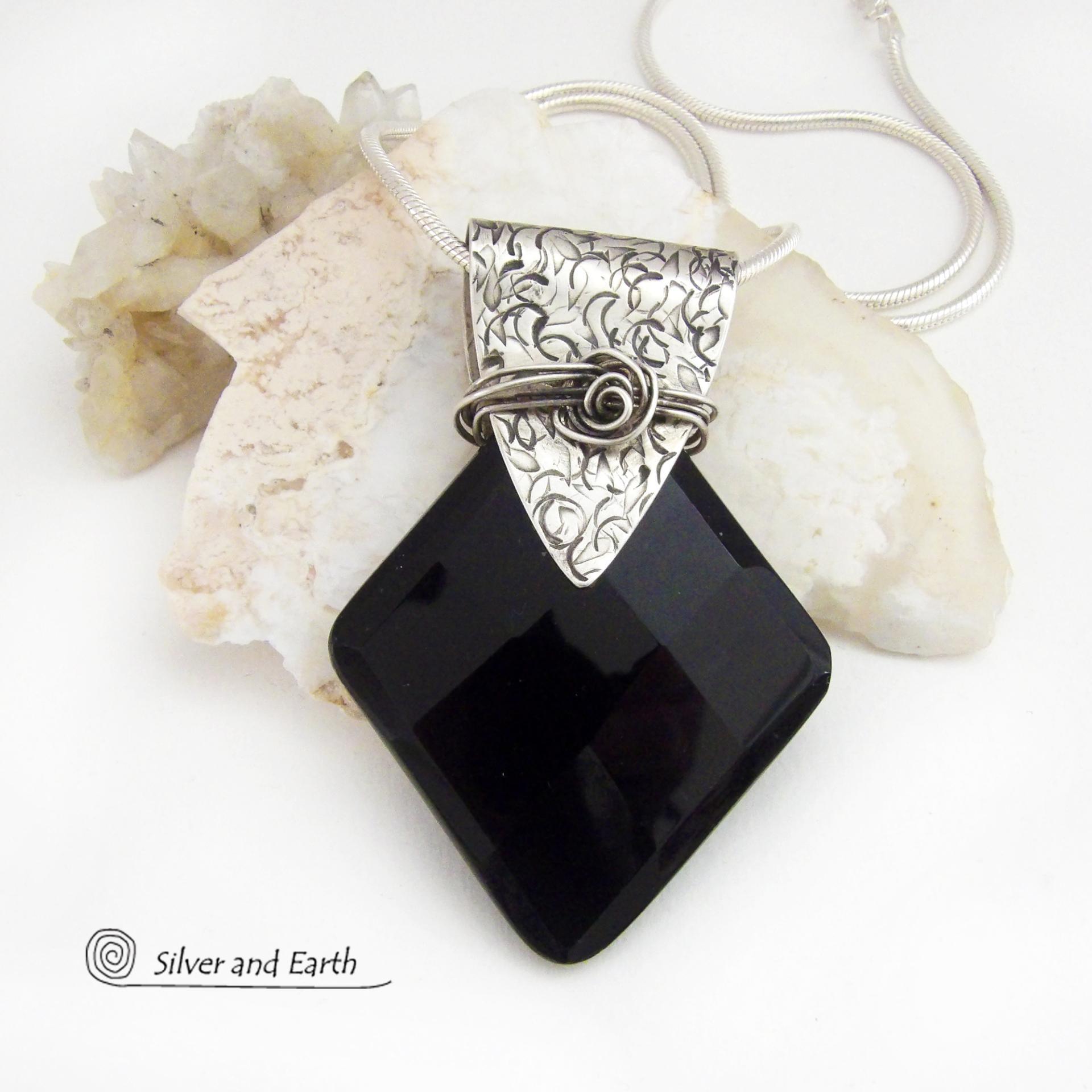 This handcrafted sterling silver necklace features a large, faceted black onyx gemstone accented with a handcrafted sterling bail. Perfect for any occasion – it will look great dressed up or down. The stone has been carved into a diamond shape and has a multi-faceted finish which casts off a natural sparkle and shine. Handmade in the USA by Silver and Earth Jewelry.