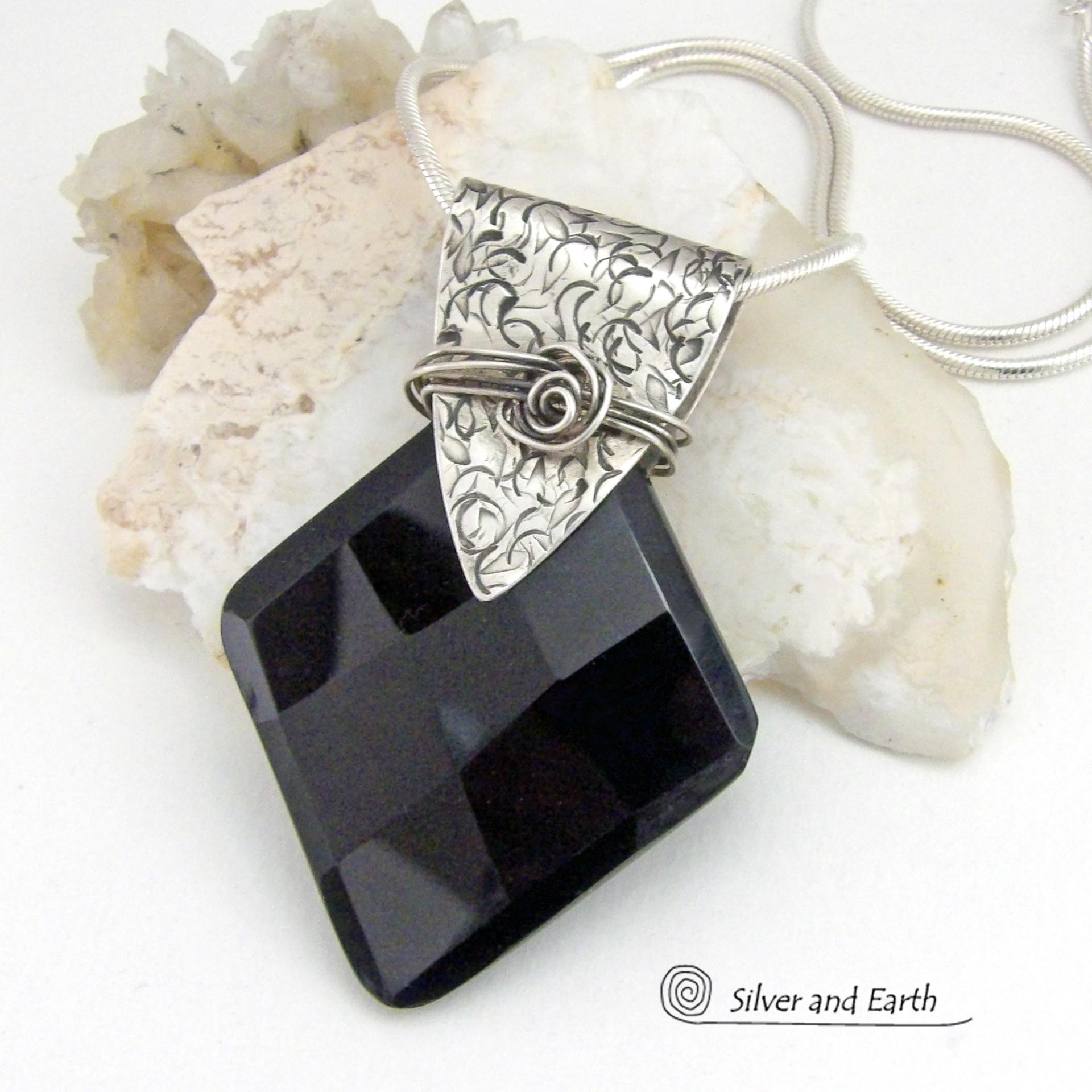 This handcrafted sterling silver necklace features a large, faceted black onyx gemstone accented with a handcrafted sterling bail. Perfect for any occasion – it will look great dressed up or down. The stone has been carved into a diamond shape and has a multi-faceted finish which casts off a natural sparkle and shine. Handmade in the USA by Silver and Earth Jewelry.