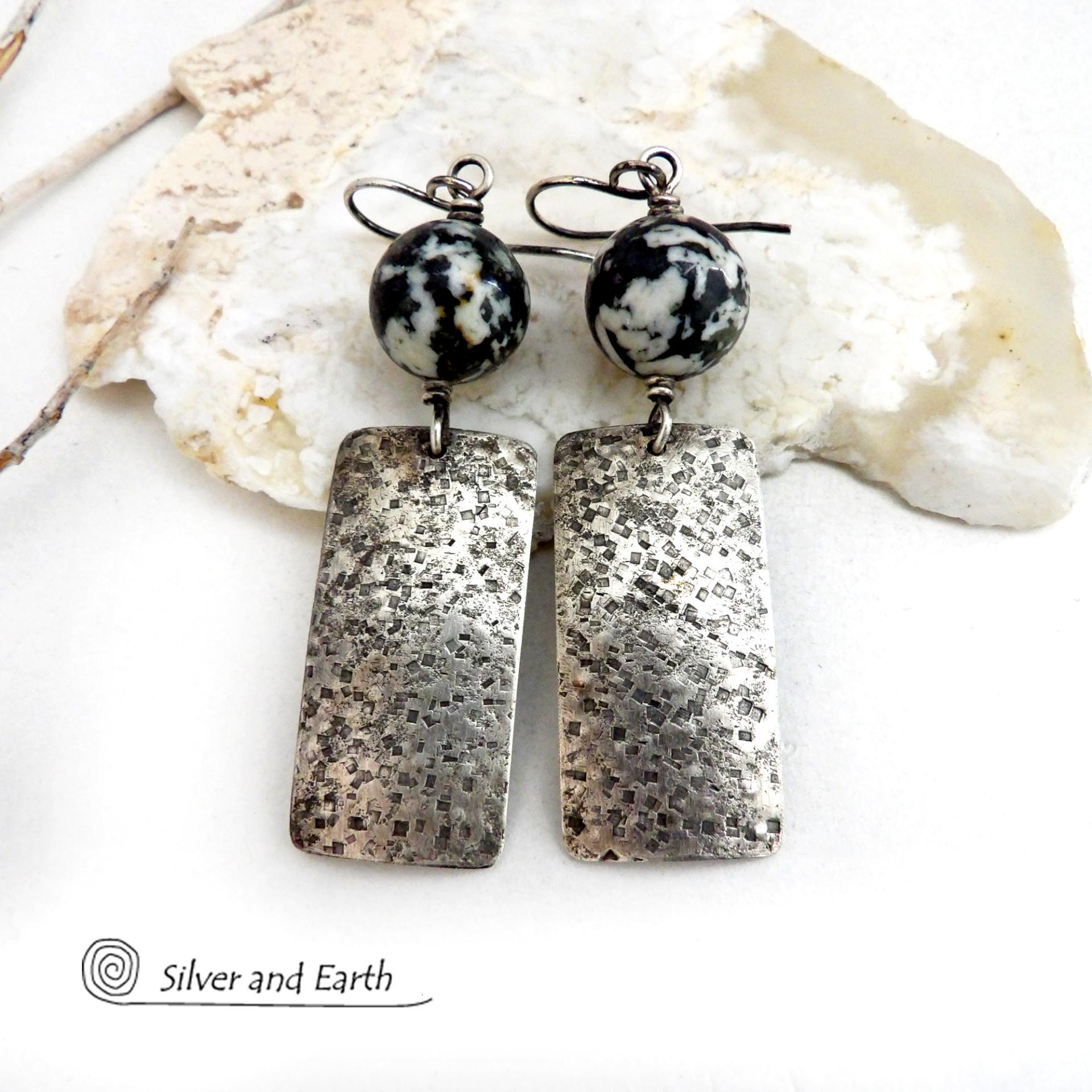 These sterling silver earrings have an earthy, organic and modern contemporary flair. They feature handcrafted sterling silver rectangles with a rustic hammered texture accented with round chunky agate gemstones. The stones have a striking natural matrix of white, gray and black speckles which create a granite-like effect. Unique and one-of-a-kind, they'll make a great gift for women that love bold unique jewelry and natural stones. 