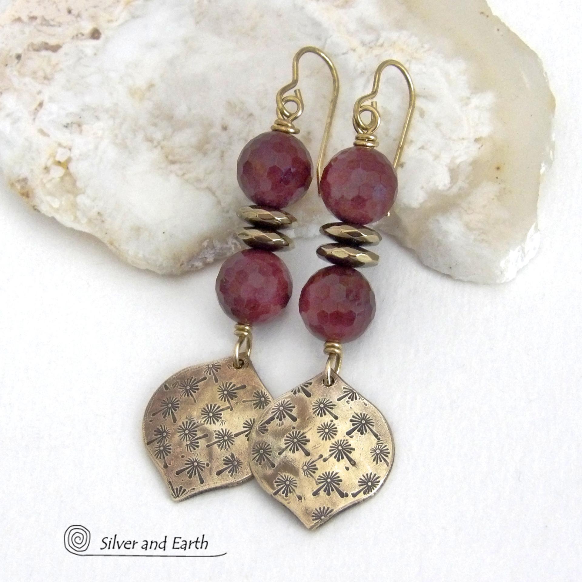 These handcrafted gold brass earrings have a hand stamped texture accented with micro-faceted deep burgundy mookaite gemstones and faceted hematite stone beads with an electroplated champagne gold tone finish. Mookaite is a unique, colorful type of jasper found at the Mooka Creek in Western Australia. These earrings have an elegant modern chic style that coordinates beautifully with all wardrobe types - dressed up or down. Handmade in the USA by Silver and Earth Jewelry.