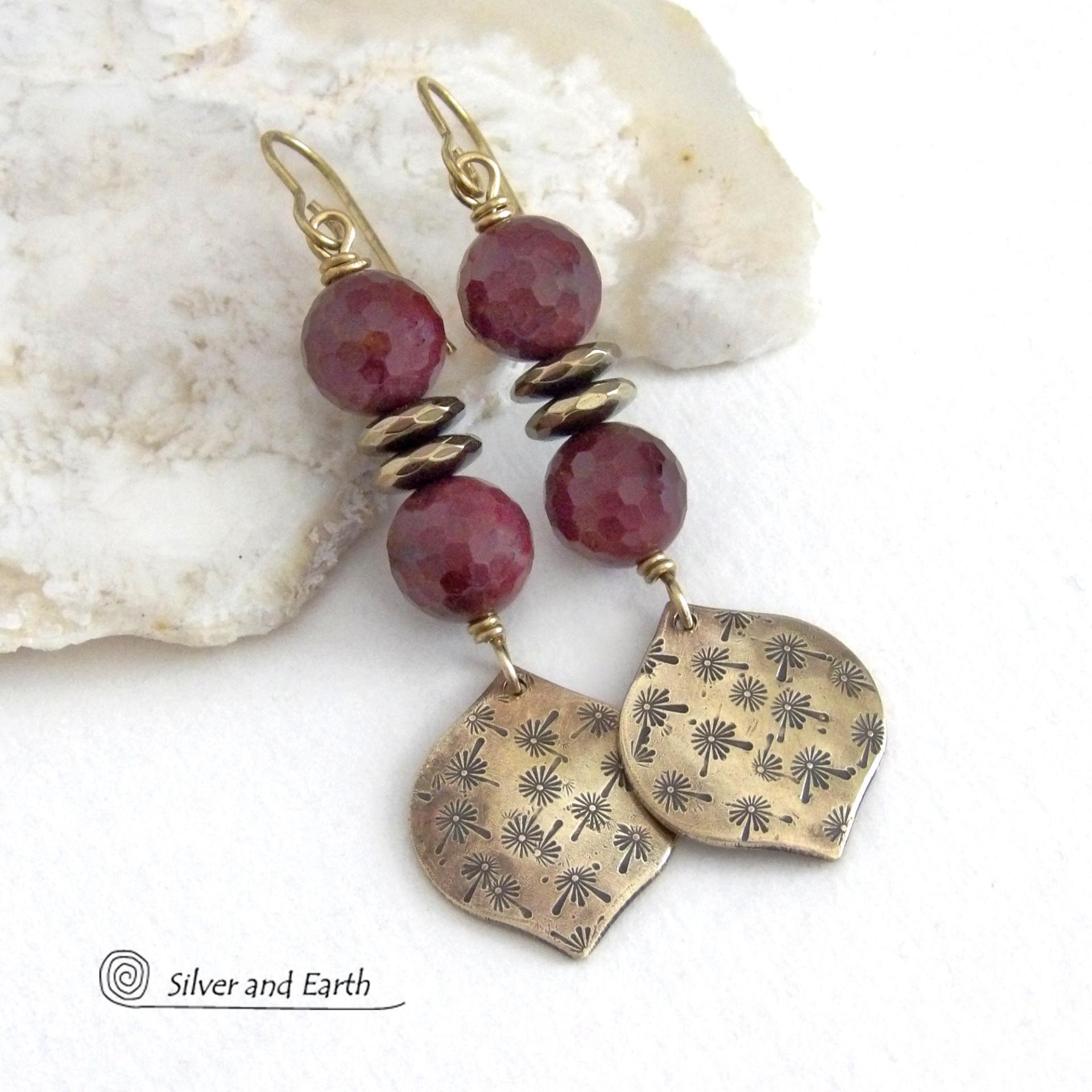 These handcrafted gold brass earrings have a hand stamped texture accented with micro-faceted deep burgundy mookaite gemstones and faceted hematite stone beads with an electroplated champagne gold tone finish. Mookaite is a unique, colorful type of jasper found at the Mooka Creek in Western Australia. These earrings have an elegant modern chic style that coordinates beautifully with all wardrobe types - dressed up or down. Handmade in the USA by Silver and Earth Jewelry.