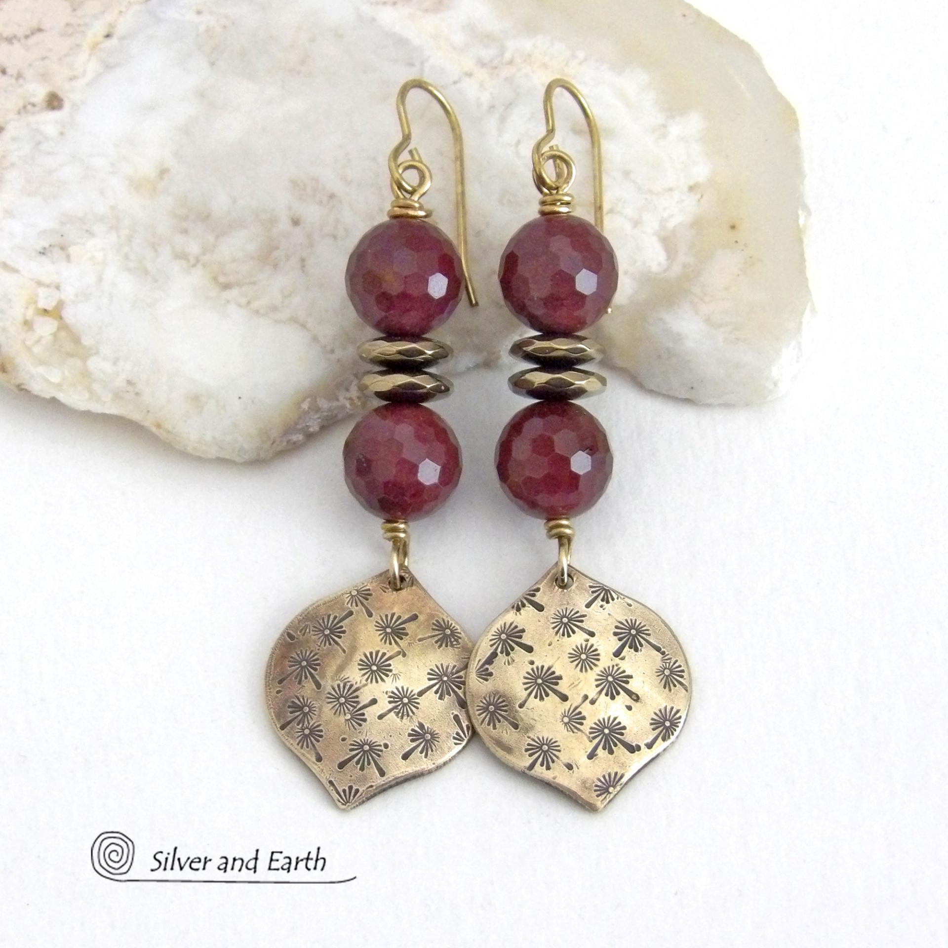 These handcrafted gold brass earrings have a hand stamped texture accented with micro-faceted deep burgundy mookaite gemstones and faceted hematite stone beads with an electroplated champagne gold tone finish. Mookaite is a unique, colorful type of jasper found at the Mooka Creek in Western Australia. These earrings have an elegant modern chic style that coordinates beautifully with all wardrobe types - dressed up or down. Handmade in the USA by Silver and Earth Jewelry.