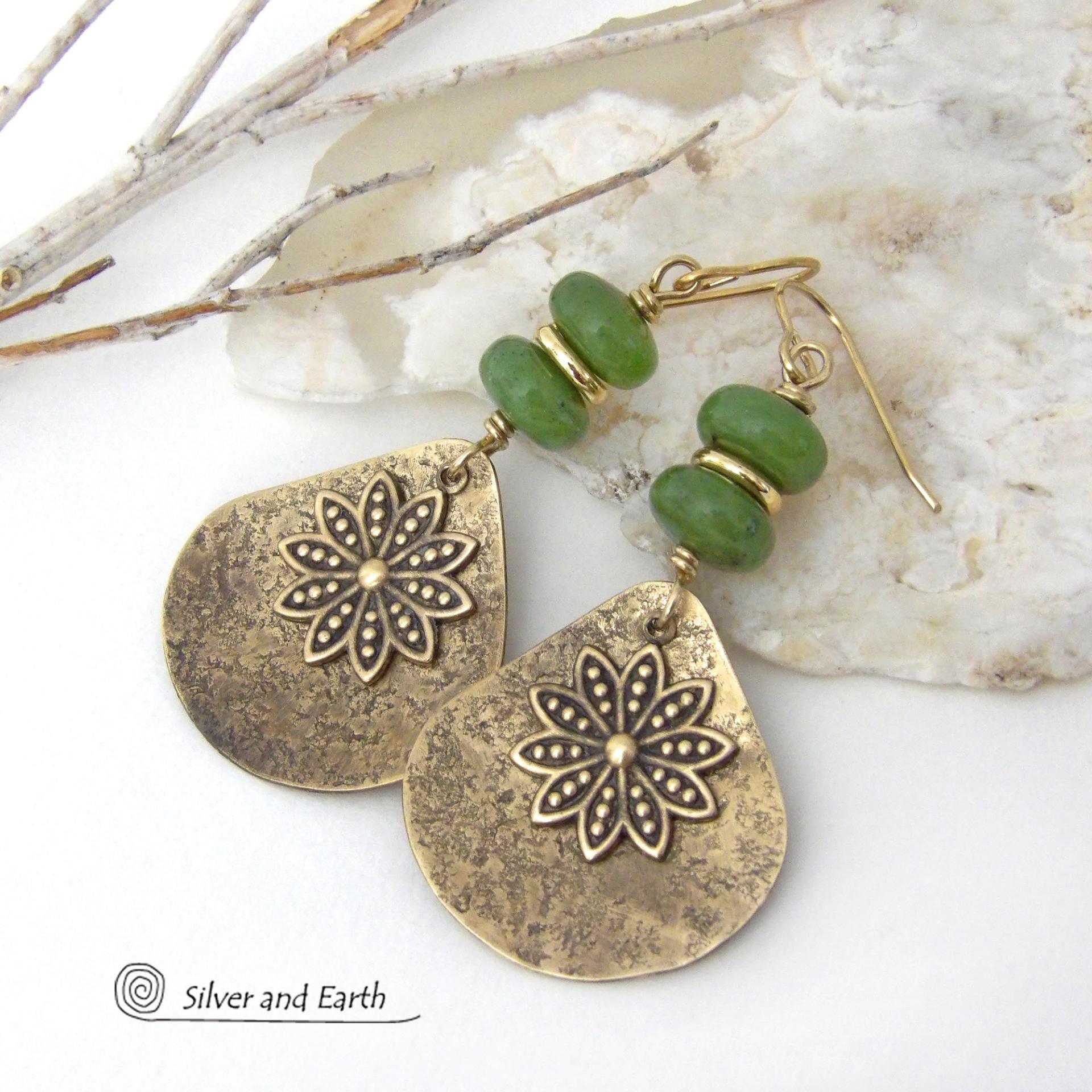 These handcrafted gold brass earrings have an earthy and modern nature-inspired charm. The design consists of brass fan-shaped dangles accented with Canadian green jade gemstones, brass flower charms and brass beads. The flowers have a lovely detailed texture and swing freely in front of the lightly hammered brass dangles. Perfect for your spring / summer wardrobe - or any time of year. They'll make a great gift for a nature and/or flower lover - or a nice addition to your own jewelry wardrobe. 