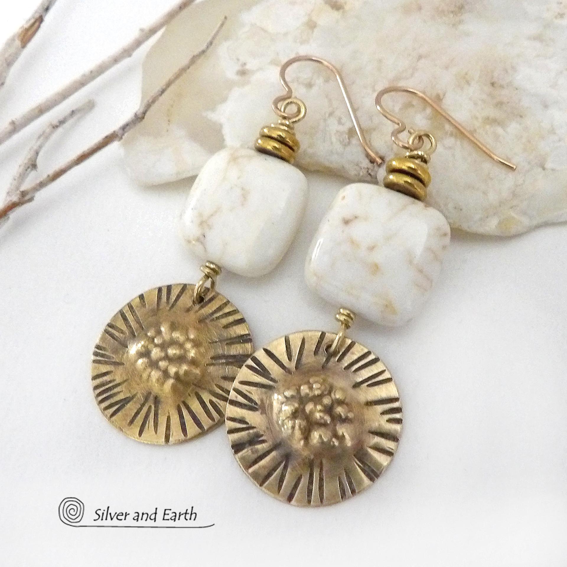 These gold brass dangle earrings have a unique hand textured design and are accented with creamy white magnesite stones. The stones have a natural matrix of golden-brown speckled inclusions and are topped off with tiny brass beads. I created the dangles out of solid gold brass sheet; and then created the texture which reminds me of the golden rays of the sun. The metal was oxidized to enhance the detail; then sealed with jeweler's wax to resist tarnishing. Handmade in the USA by Silver and Earth Jewelry.