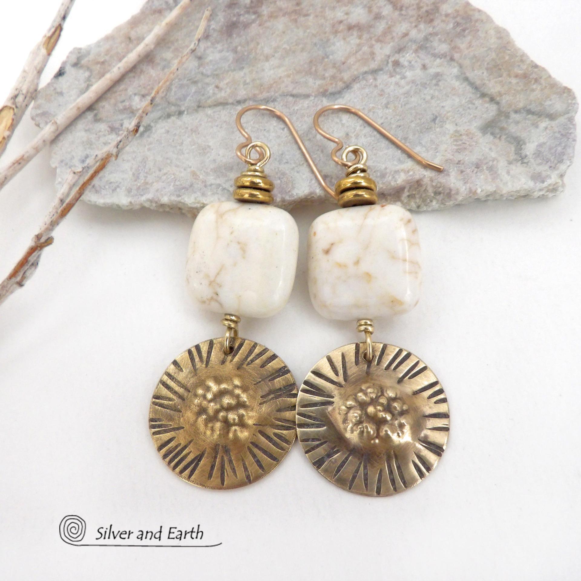 These gold brass dangle earrings have a unique hand textured design and are accented with creamy white magnesite stones. The stones have a natural matrix of golden-brown speckled inclusions and are topped off with tiny brass beads. I created the dangles out of solid gold brass sheet; and then created the texture which reminds me of the golden rays of the sun. The metal was oxidized to enhance the detail; then sealed with jeweler's wax to resist tarnishing. Handmade in the USA by Silver and Earth Jewelry.