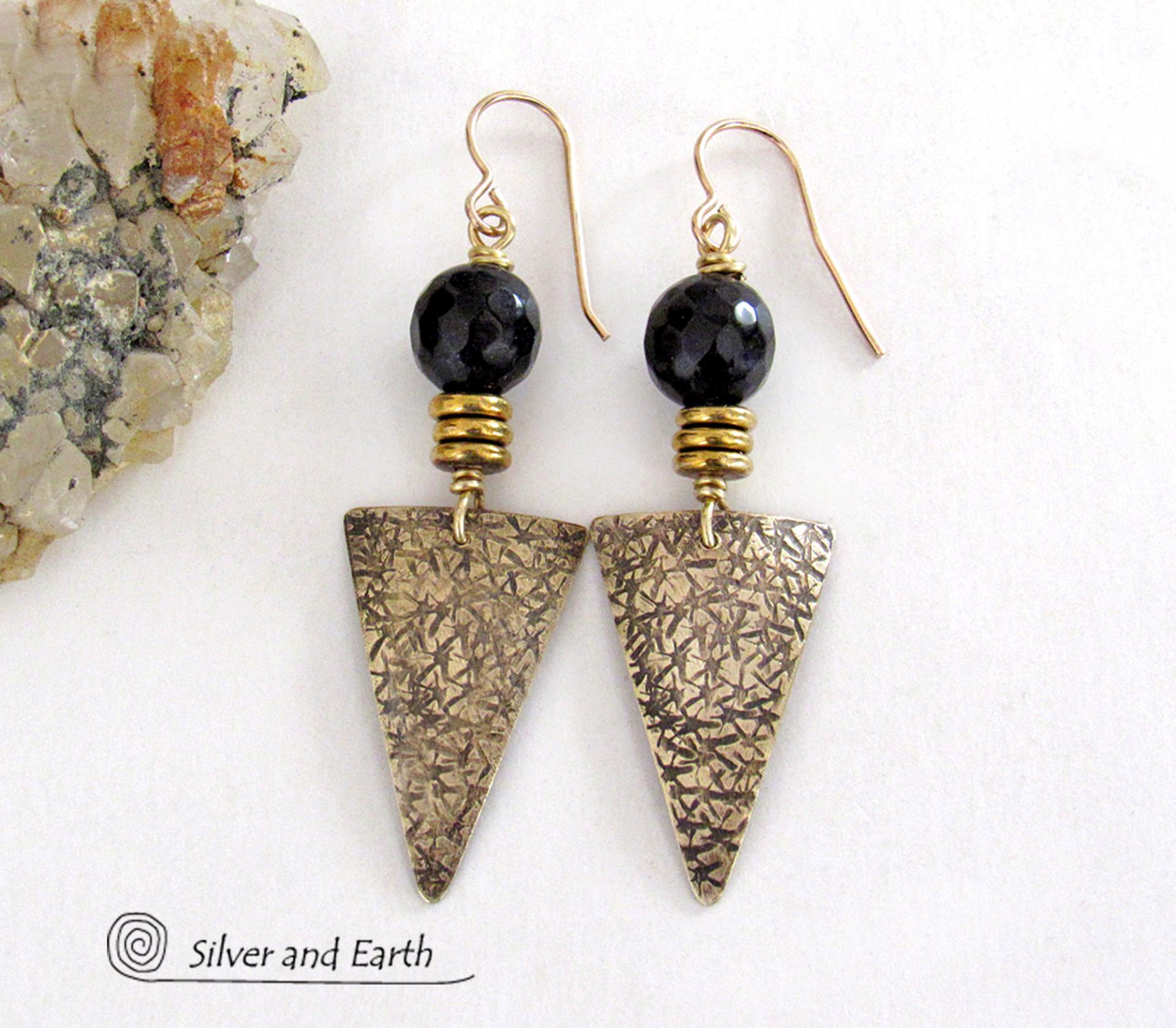 These gold brass triangle earrings have a hand stamped texture and are accented with black onyx gemstones above a stack of tiny brass beads. The stones have a faceted finish which gives off a natural sparkle and shine. Lightweight and comfortable to wear - they have a modern chic contemporary style that coordinates well with all wardrobes types. Handmade in the USA by Silver and Earth Jewelry.