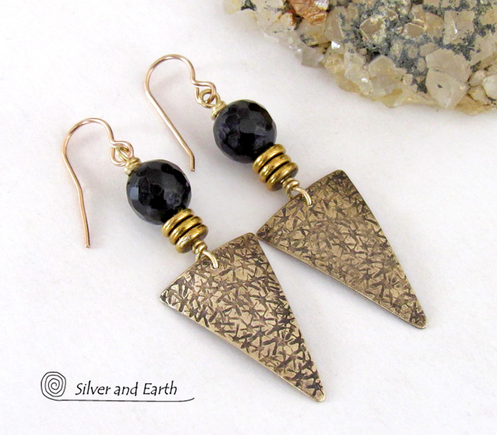 These gold brass triangle earrings have a hand stamped texture and are accented with black onyx gemstones above a stack of tiny brass beads. The stones have a faceted finish which gives off a natural sparkle and shine. Lightweight and comfortable to wear - they have a modern chic contemporary style that coordinates well with all wardrobes types. Handmade in the USA by Silver and Earth Jewelry.