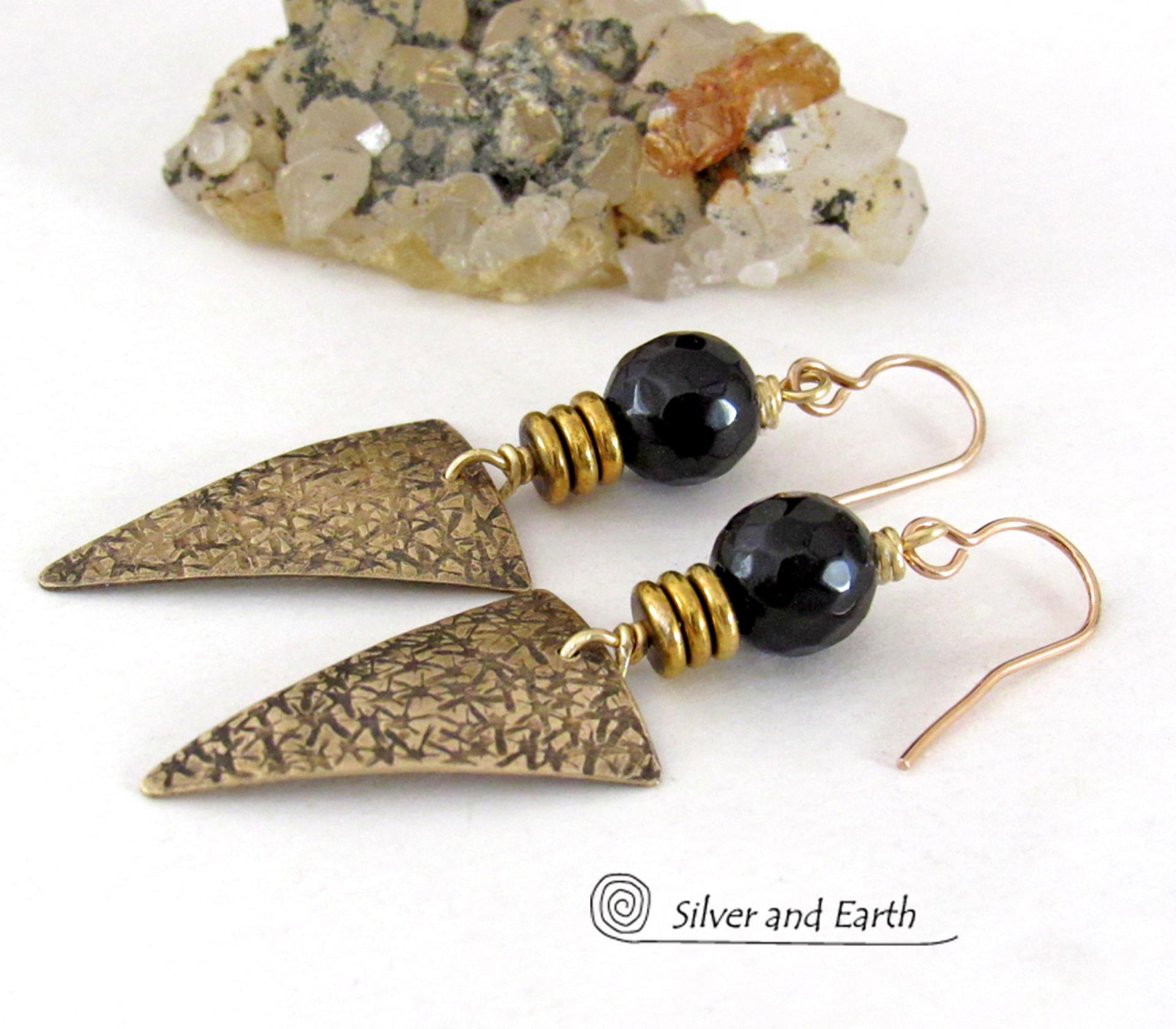 These gold brass triangle earrings have a hand stamped texture and are accented with black onyx gemstones above a stack of tiny brass beads. The stones have a faceted finish which gives off a natural sparkle and shine. Lightweight and comfortable to wear - they have a modern chic contemporary style that coordinates well with all wardrobes types. Handmade in the USA by Silver and Earth Jewelry.