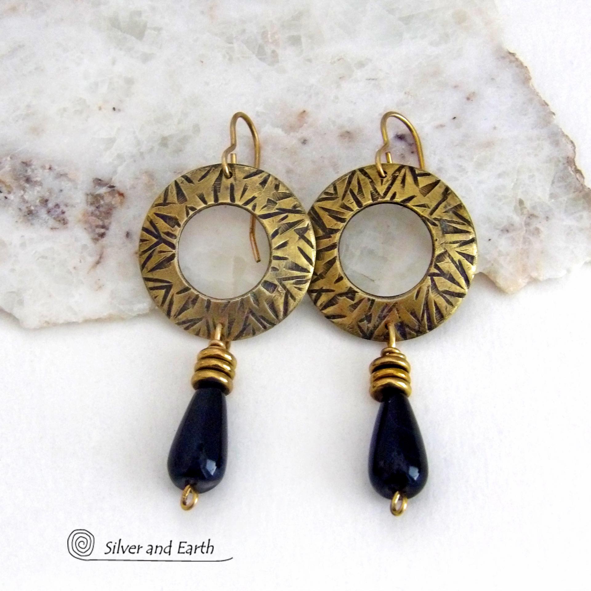 These handcrafted gold brass earrings have a hand stamped texture and are accented with teardrop shaped black onyx gemstones and brass beads. They have a modern chic vibe that coordinates beautifully with all wardrobe styles. Perfect for women that love to wear one of a kind artisan handcrafted jewelry. Handmade in the USA by Silver and Earth Jewelry. Total length of approximately 2-1/4" from top of brass ear wires and 1” at widest point. 