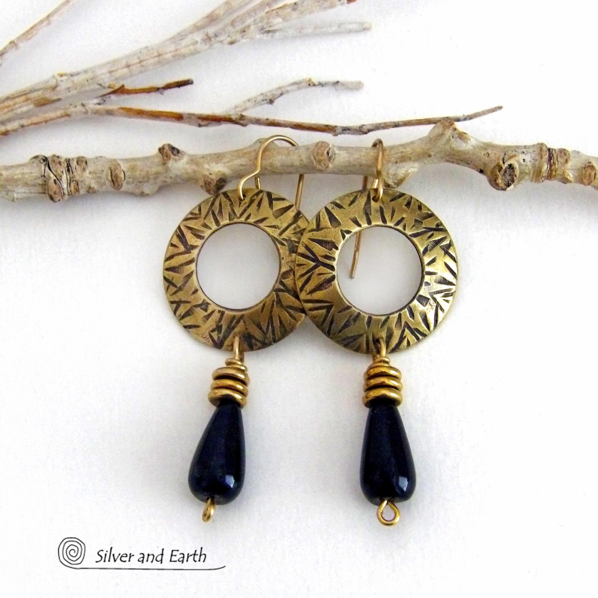 These handcrafted gold brass earrings have a hand stamped texture and are accented with teardrop shaped black onyx gemstones and brass beads. They have a modern chic vibe that coordinates beautifully with all wardrobe styles. Perfect for women that love to wear one of a kind artisan handcrafted jewelry. Handmade in the USA by Silver and Earth Jewelry. Total length of approximately 2-1/4" from top of brass ear wires and 1” at widest point. 