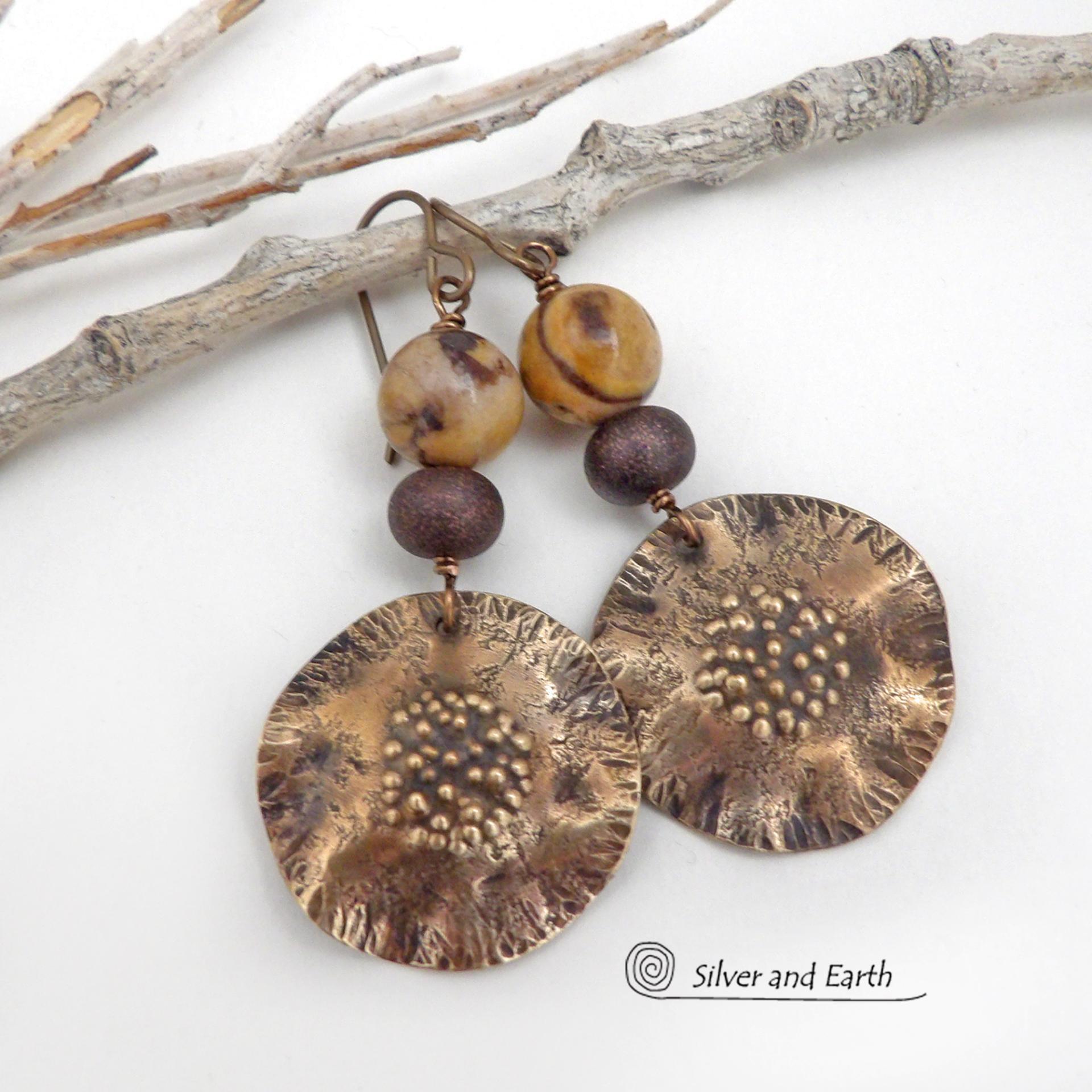 These earrings feature hand-forged bronze metal dangles accented with natural jasper stones and bronze glass beads. They have an earthy, modern boho feel that makes a striking statement. Perfect for women that love unique artisan handcrafted jewelry, earthy hammered textures and natural stones. Handmade in the USA by Silver and Earth Jewelry.