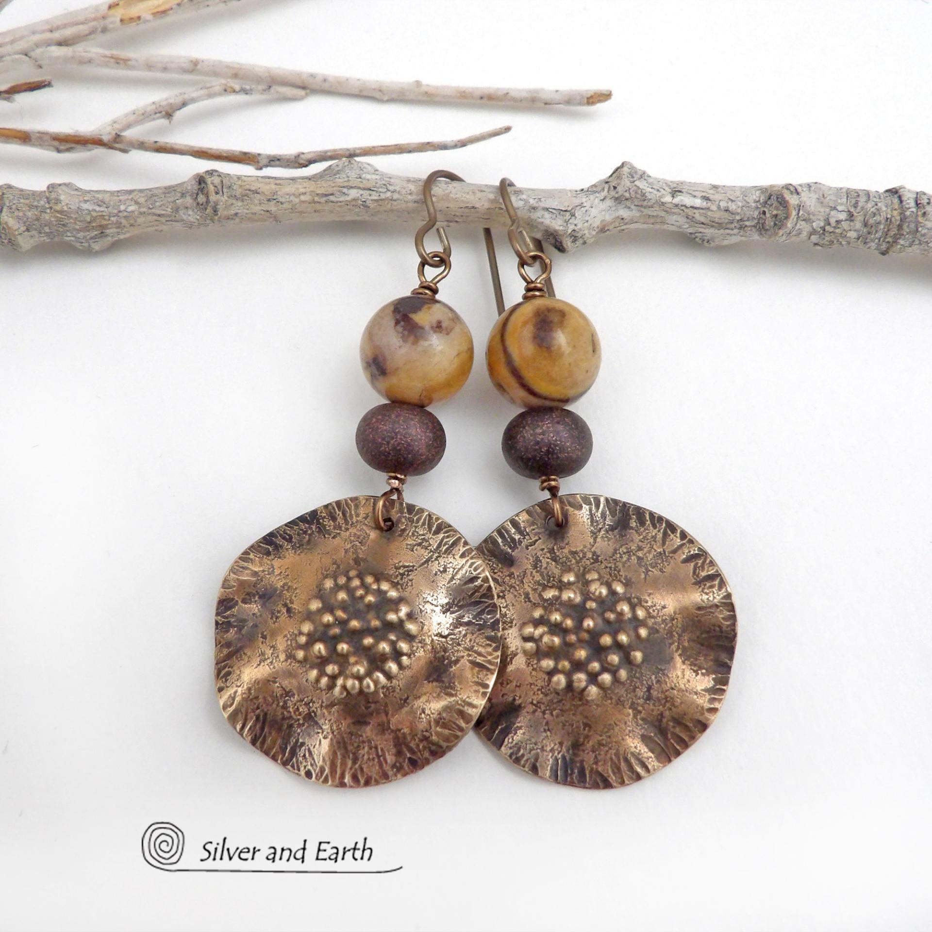 These earrings feature hand-forged bronze metal dangles accented with natural jasper stones and bronze glass beads. They have an earthy, modern boho feel that makes a striking statement. Perfect for women that love unique artisan handcrafted jewelry, earthy hammered textures and natural stones. Handmade in the USA by Silver and Earth Jewelry.