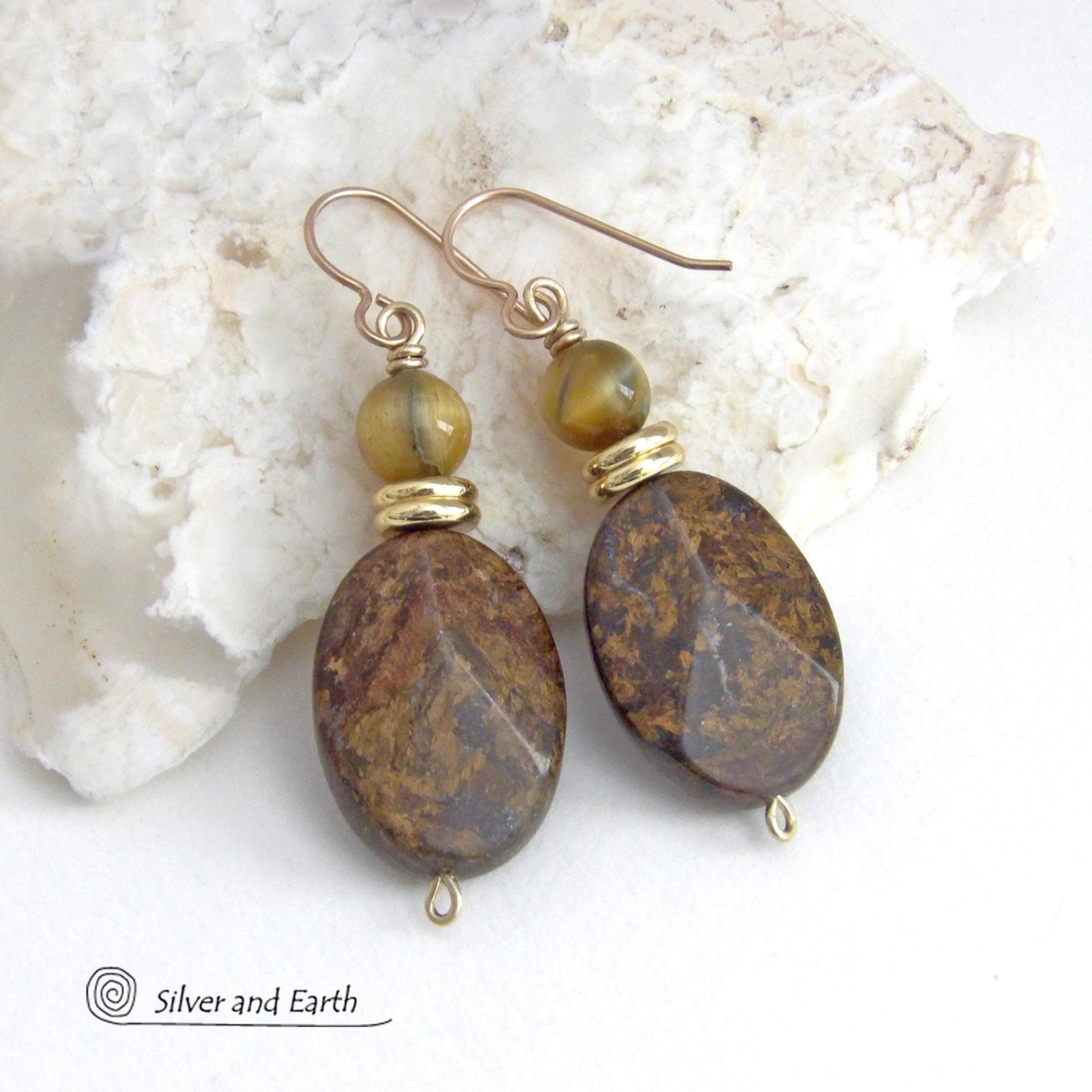 These handcrafted earrings feature natural bronzite gemstones with a faceted finish accented with golden tiger's eye gemstones and shiny brass beads. The bronzite stones have a beautiful chocolate brown hue with subtle *gold tone* metallic inclusions. Bronzite is a blend of several minerals which gives it a unique mottled appearance. They have a modern, earthy appeal and will make a great gift for a nature lover - or an interesting addition to your own jewelry wardrobe. Handmade in the USA by Silver and Ear
