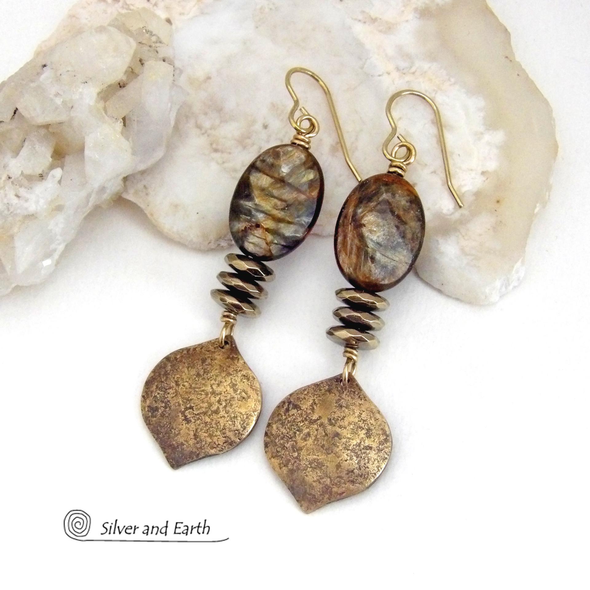 These handcrafted earrings feature gold brass dangles with a hammered organic texture accented with natural brown mica gemstones and faceted hematite stones with an electroplated champagne gold finish. The stones have a beautiful brown hue with undertones of shimmery gold and a faceted finish which casts off a natural sparkle and shine. They have a modern, chic and elegant style that coordinates beautifully with all wardrobe types - dressed up or down.