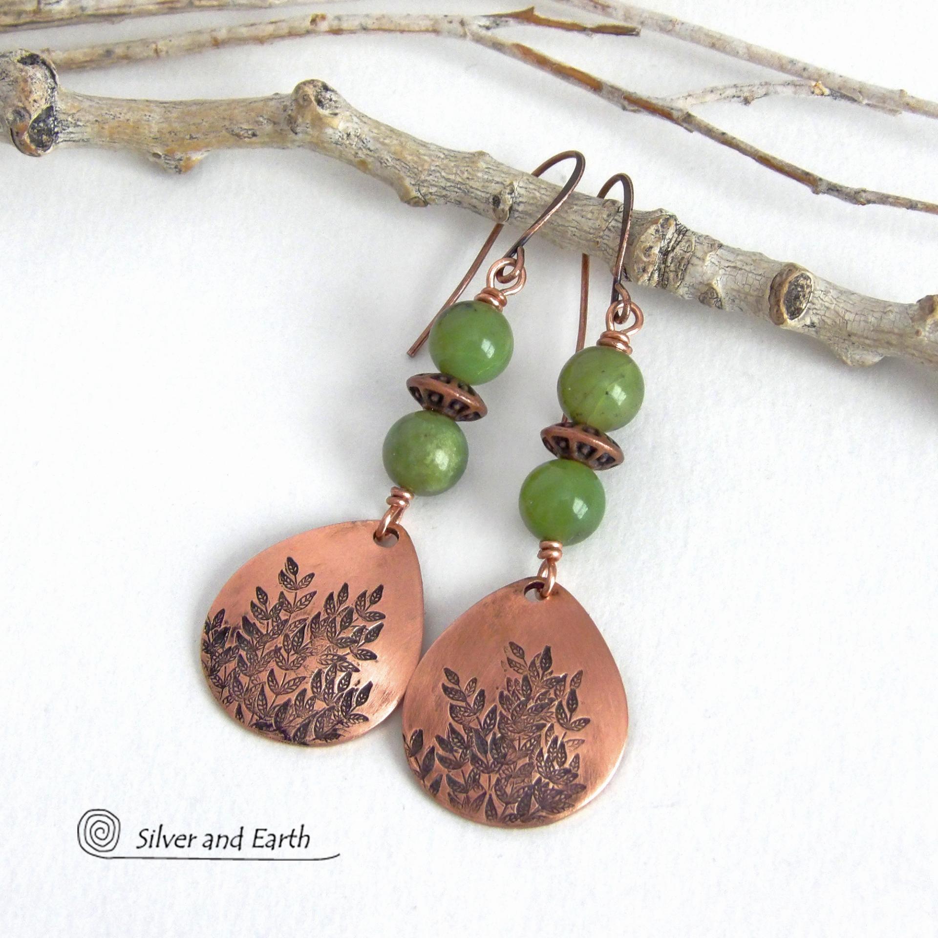 These handcrafted earrings feature teardrop shaped copper dangles with a hand-stamped leaf texture accented with natural green jade gemstones and copper beads. They have an earthy, modern style that coordinates well with all wardrobe styles. They'll make a great gift for a nature lover - or a nice addition to your own jewelry wardrobe. Your choice of copper ear wires or niobium hypoallergenic ear wires. Earrings are handmade in the USA by Silver and Earth Jewelry. 