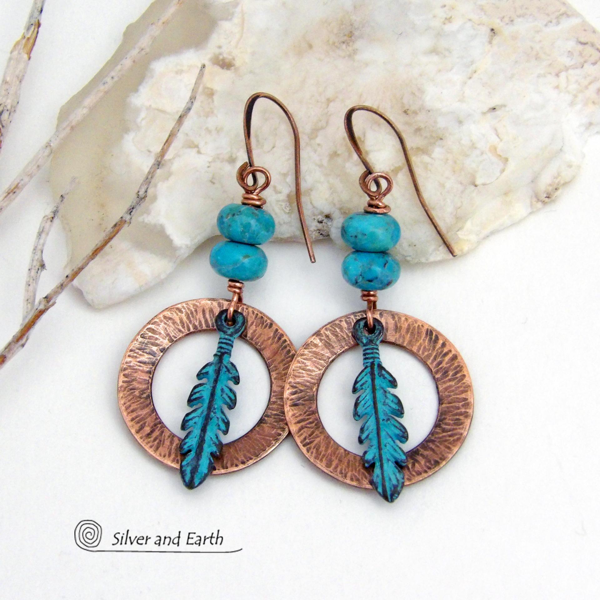 These handcrafted earrings feature round copper hoops with a hammered texture accented with a stack of turquoise beads and patina blue verdigris feathers. Lightweight and comfortable to wear - they'll add a touch of boho southwestern style to your wardrobe. Handmade in the USA by Silver and Earth Jewelry. 