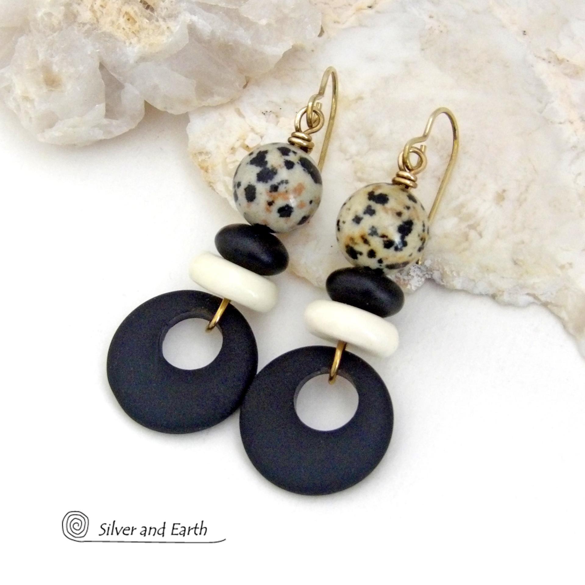 These handcrafted earrings feature matte black glass circle hoops accented with Dalmatian jasper gemstones, African bone and black glass beads. Unique and fun to wear, they have an earthy natural style with boho chic flair that makes a striking statement. They'll make a great gift for a natural stone lover - or a nice addition to your own jewelry wardrobe. 
