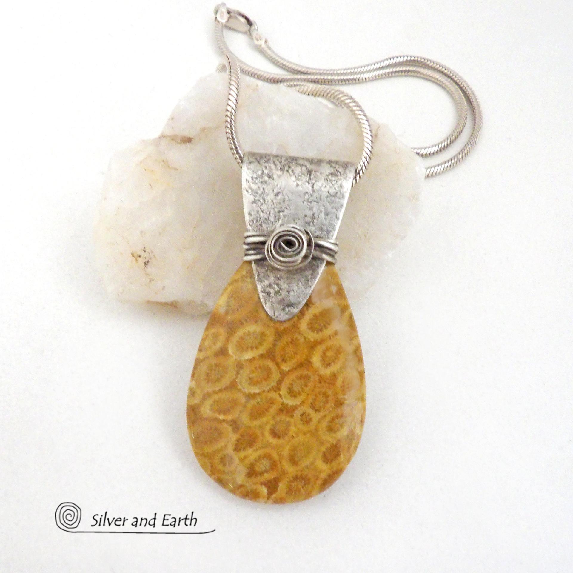 This unique *one-of-a-kind* necklace features a gorgeous fossil coral stone accented with a handcrafted sterling silver bail. Agatized fossil coral is a natural stone formed when ancient coral is gradually replaced with agate. The fossilized coral appear as small "flower-like" markings in the stone, resulting in terrific patterns. This necklace will make a great gift for anyone that loves natural stone jewelry -- or a nice addition to your own jewelry collection.