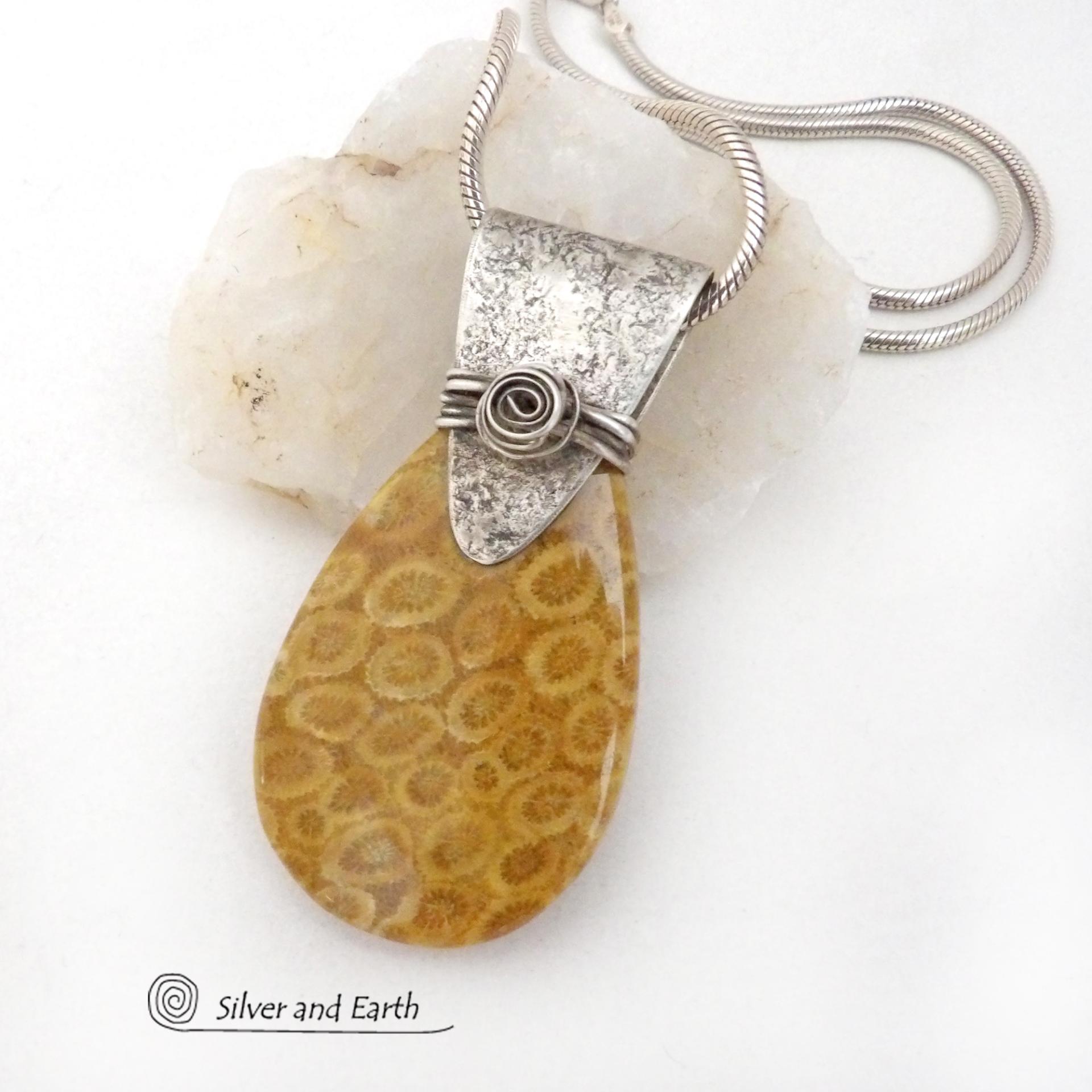 This unique *one-of-a-kind* necklace features a gorgeous fossil coral stone accented with a handcrafted sterling silver bail. Agatized fossil coral is a natural stone formed when ancient coral is gradually replaced with agate. The fossilized coral appear as small "flower-like" markings in the stone, resulting in terrific patterns. This necklace will make a great gift for anyone that loves natural stone jewelry -- or a nice addition to your own jewelry collection.