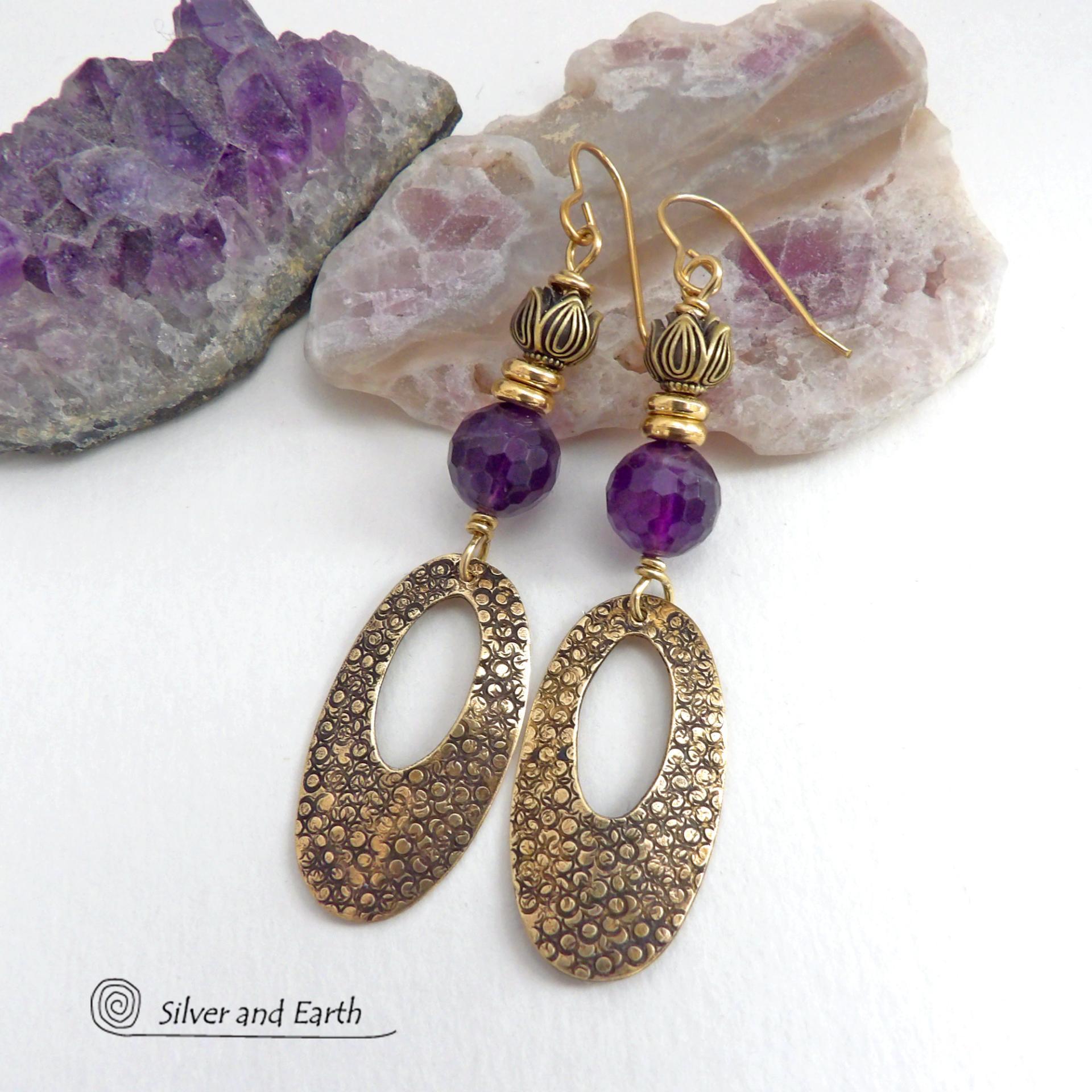 These handcrafted gold brass earrings have a hand stamped texture and are accented with faceted purple amethyst gemstones, tiny brass beads and tulip flower-shaped beads. Exotic and unique, they have an elegant chic Egyptian style vibe that makes a bold statement. They'll make a great gift for someone born in February - Amethyst is February's birthstone. Handmade in the USA by Silver and Earth Jewelry. 