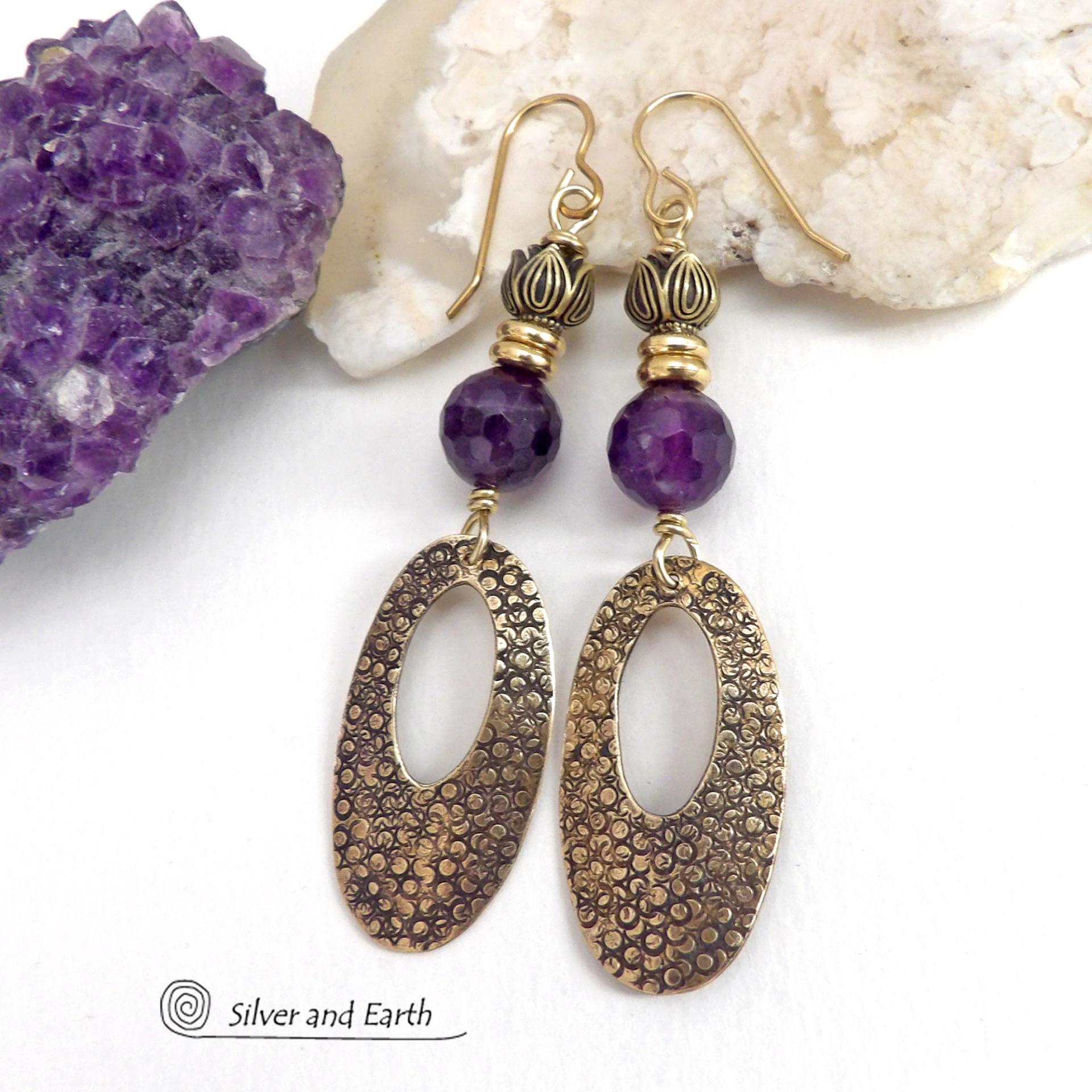 These handcrafted gold brass earrings have a hand stamped texture and are accented with faceted purple amethyst gemstones, tiny brass beads and tulip flower-shaped beads. Exotic and unique, they have an elegant chic Egyptian style vibe that makes a bold statement. They'll make a great gift for someone born in February - Amethyst is February's birthstone. Handmade in the USA by Silver and Earth Jewelry. 